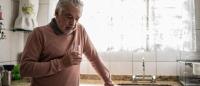 older latino man drinking water